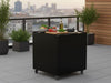 byJEMA Outdoor-Kuechentisch aus schwarz lackiertem Stahl mit Rollen auf moderner Terrasse mit Stadtblick