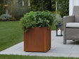 CUBY Pflanzkasten aus Cortenstahl mit üppiger Bepflanzung im Garten