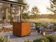 CUBY Feuergrill aus Cortenstahl auf Terrasse bei Sonnenuntergang mit Loungemöbeln